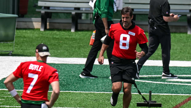 QB Aaron Rodgers pulls a weight during warmups on May 23