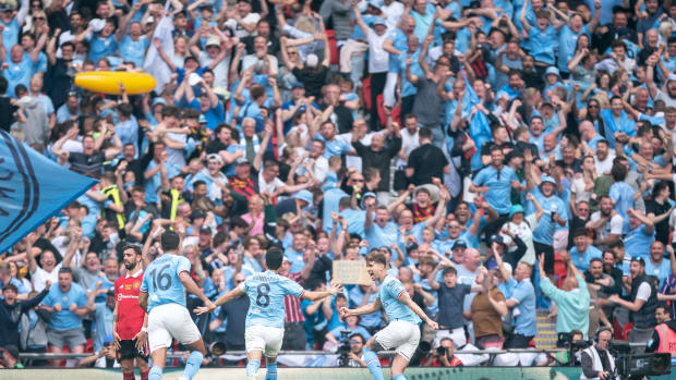 Manchester City players and supporters pictured celebrating a goal during their 2-1 win over Manchester United in the 2023 FA Cup final at Wembley