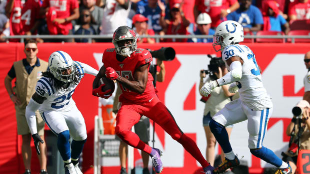 Dec 8, 2019; Tampa, FL, USA;Tampa Bay Buccaneers wide receiver Breshad Perriman (19) runs with the ball as Indianapolis Colts defensive back George Odum (30) and free safety Malik Hooker (29) defends during the first half at Raymond James Stadium.