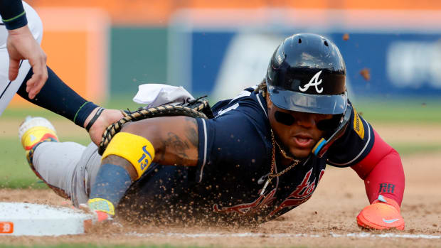 Jun 14, 2023; Detroit, Michigan, USA; Atlanta Braves right fielder Ronald Acuna Jr. (13) dives back to first ahead of the tag against the Detroit Tigers in the seventh inning at Comerica Park.