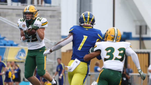 North Dakota State safety Michael Tutsie (left) makes an interception in front of Delaware receiver Thyrick Pitts (1) and defensive back Destin Talbert in the first quarter at Delaware Stadium Saturday Ud V North Dakota