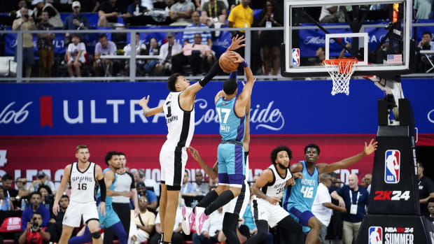 San Antonio Spurs forward Victor Wembanyama (1) attempts to block a shot from Charlotte Hornets guard Amari Bailey (17) during the second half at Thomas & Mack Center.