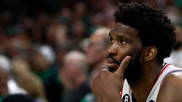 Joel Embiid sits with his hand on his chin