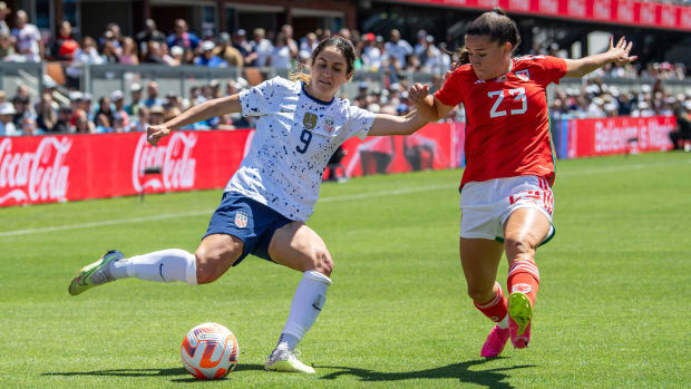 USWNT midfielder Savannah Demelo and Ffion Morgan of Wales battle for the battle in the USWNT's send-off game before the World Cup.