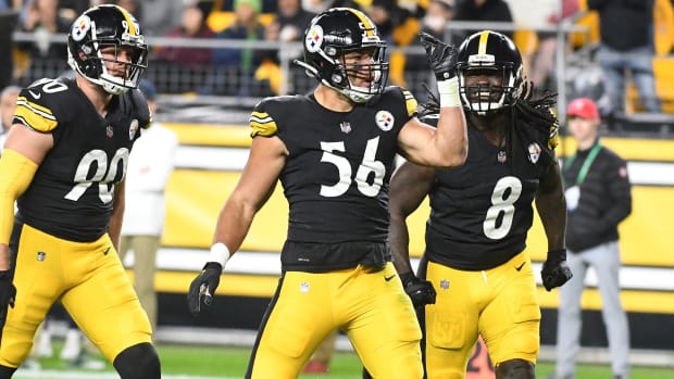 Steelers linebacker Alex Highsmith (56) celebrates a sack with linebacker T.J. Watt (90) and linebacker Melvin Ingram III during a game against the Seahawks.