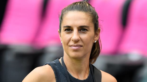 Former USWNT player Carli Lloyd looks on before a NWSL game.