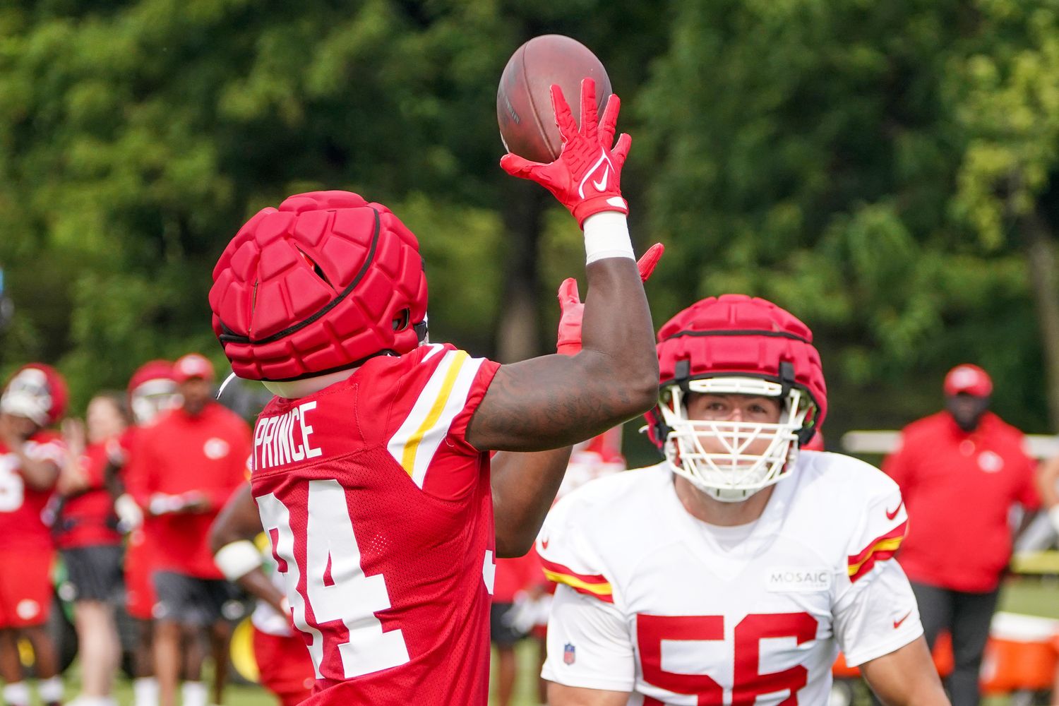 Jul 24, 2023; St. Joseph, MO, USA; Kansas City Chiefs running back Deneric Prince (34) catches a pass as defensive end George Karlaftis (56) defends during training camp at Missouri Western State University. Mandatory Credit: Denny Medley-USA TODAY Sports