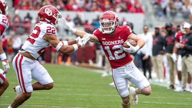 Oklahoma Red Team's Drake Stoops (12) stiff arms Oklahoma White Team's Peyton Bowen (22) during a spring scrimmage game at Gaylord Family Oklahoma Memorial Stadium in Norman Okla., on Saturday, April 22, 2023.