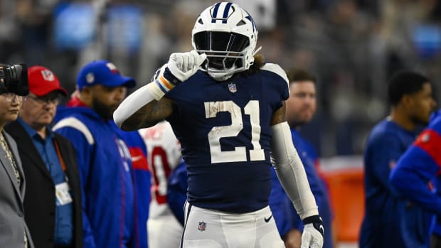 Cowboys running back Ezekiel Elliott celebrates running for a first down in a game.