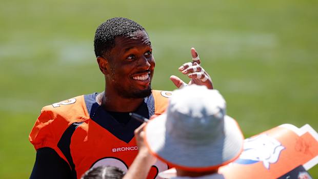 Denver Broncos defensive tackle Jonathan Harris (92) greets fans after training camp at Centura Health Training Center.
