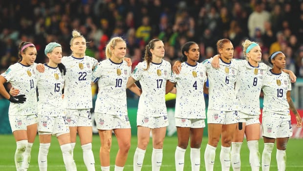 USWNT players link up while looking on during penalty kicks against Sweden at the Women's World Cup.