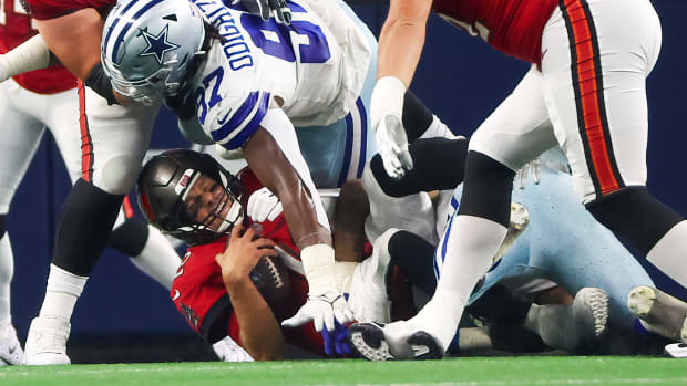 Sep 11, 2022; Arlington, Texas, USA; Dallas Cowboys linebacker Micah Parsons (11) and defensive tackle Osa Odighizuwa (97) sack Tampa Bay Buccaneers quarterback Tom Brady (12) during the second quarter at AT&T Stadium. Mandatory Credit: Kevin Jairaj-USA TODAY Sports