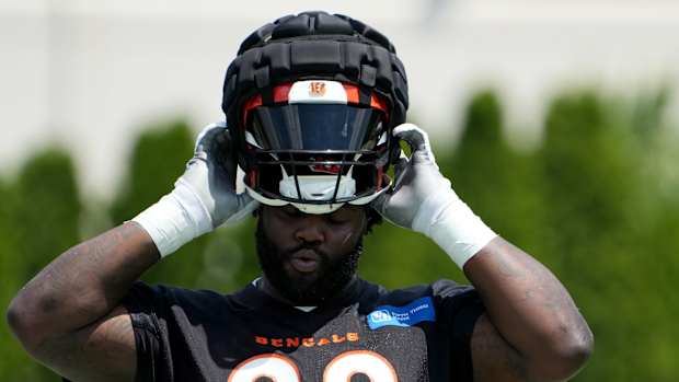 Cincinnati Bengals defensive tackle DJ Reader (98) puts on his helmet during NFL training camp practice, Monday, July 31, 2023, in Cincinnati.