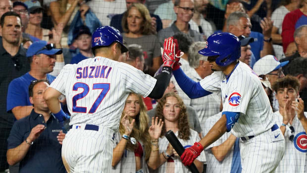 Aug 2, 2023; Chicago, Illinois, USA; Chicago Cubs right fielder Seiya Suzuki (27) is greeted by designated hitter Christopher Morel (5) after scoring against the Cincinnati Reds during the sixth inning at Wrigley Field. Mandatory Credit: David Banks-USA TODAY Sports