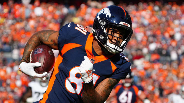 Denver Broncos wide receiver Tim Patrick (81) carries the ball for a touchdown in the first quarter against the Las Vegas Raiders at Empower Field at Mile High.