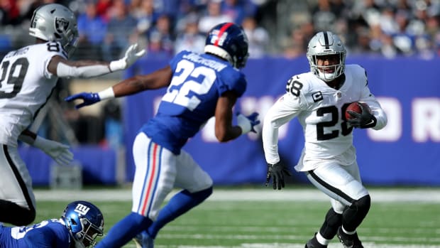 Nov 7, 2021; East Rutherford, New Jersey, USA; Las Vegas Raiders running back Josh Jacobs (28) runs the ball against New York Giants cornerback Adoree' Jackson (22) during the first quarter at MetLife Stadium.