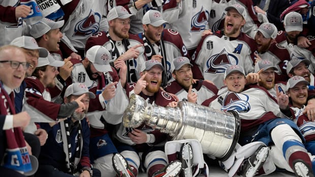 The Colorado Avalanche pose with the Stanley Cup after defeating the Tampa Bay Lightning 2-1 in Game 6 of the NHL hockey Stanley Cup Finals on Sunday, June 26, 2022, in Tampa, Fla.