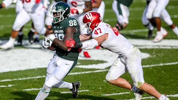 Michigan State's Trenton Gillison, left, catches a pass as Indiana's Micah McFadden closes in during the third quarter on Saturday, Nov. 14, 2020, at Spartan Stadium in East Lansing.