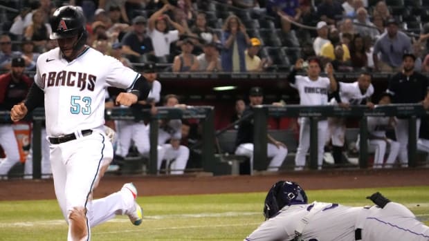 Jul 7, 2022; Phoenix, Arizona, USA; Arizona Diamondbacks first baseman Christian Walker (53) beats the tag of Colorado Rockies catcher Elias Diaz (35) to score a run during the fourth inning at Chase Field. Mandatory Credit: Joe Camporeale-USA TODAY Sports
