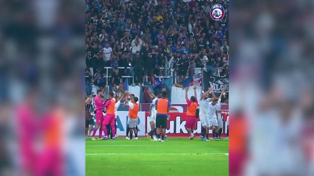 Arema FC players and fans celebrate after win away at PSIS