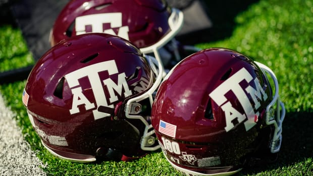A detailed view of Texas A&M Aggies helmets on the sideline.