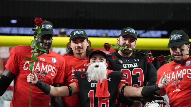 Utah Utes wide receiver Britain Covey (18), quarterback Cameron Rising (7) and Utah Utes long snapper Keegan Markgraf (93) celebrate after the 2021 Pac-12 Championship Game against the Oregon Ducks at Allegiant Stadium.Utah defeated Oregon 38-10.