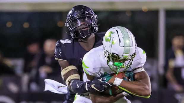 UCF safety Divaad Wilson tackling USF running back Darrian Felix - 2021