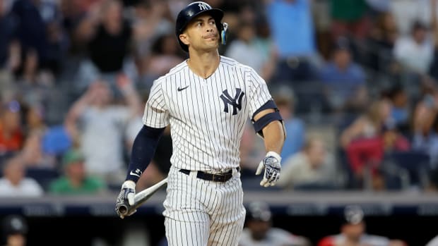 New York Yankees OF Giancarlo Stanton watches home run