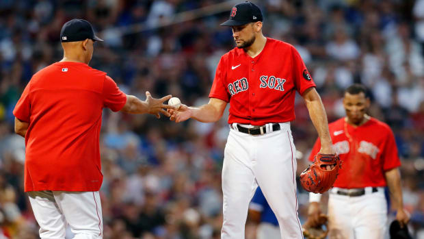 Boston Red Sox’s Nathan Eovaldi hands the ball to manager Alex Cora as he is removed during the third inning of the team’s baseball game against the Toronto Blue Jays, Friday, July 22, 2022, in Boston.