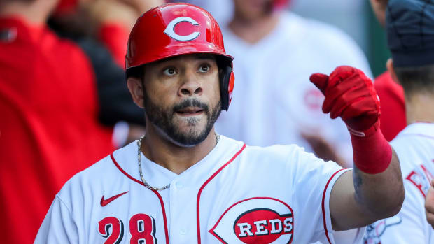 Reds left fielder Tommy Pham (28) high fives teammates after scoring on a two-run double hit by shortstop Kyle Farmer (not pictured) in the first inning.