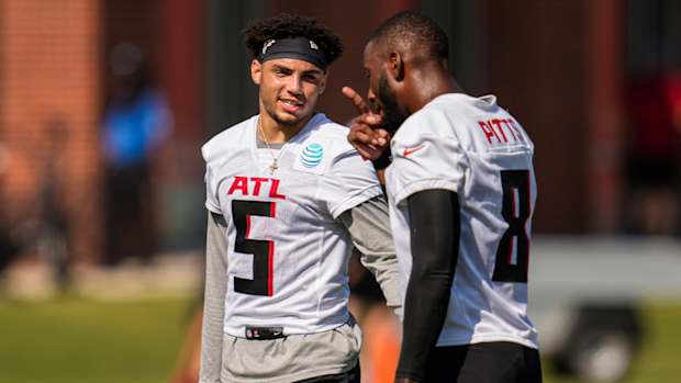 Jul 29, 2022; Flowery Branch, GA, USA; Atlanta Falcons wide receiver Drake London (5) talks to tight end Kyle Pitts (8) during training camp at IBM Performance Field.
