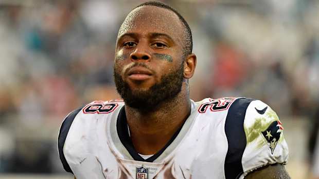 Patriots running back James White runs off the field after a game.