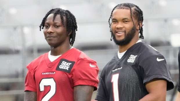 Aug 8, 2022; Glendale, Arizona, U.S.; Arizona Cardinals wide receiver Marquise Brown (2) and quarterback Kyler Murray (1) watch during training camp at State Farm Stadium.