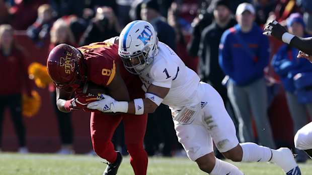 Nov 23, 2019; Ames, IA, USA; Iowa State Cyclones wide receiver Deshaunte Jones (8) is tackled by Kansas Jayhawks safety Bryce Torneden (1) at Jack Trice Stadium. Mandatory Credit: Reese Strickland-USA TODAY Sports