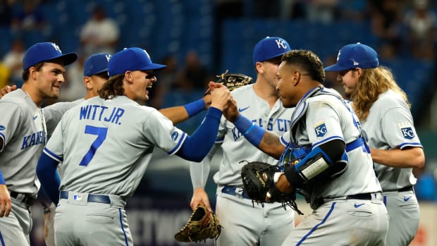 Aug 19, 2022; St. Petersburg, Florida, USA; Kansas City Royals catcher Salvador Perez (13), shortstop Bobby Witt Jr. (7) and teammates celebrates as they beat the Tampa Bay Rays at Tropicana Field. Mandatory Credit: Kim Klement-USA TODAY Sports