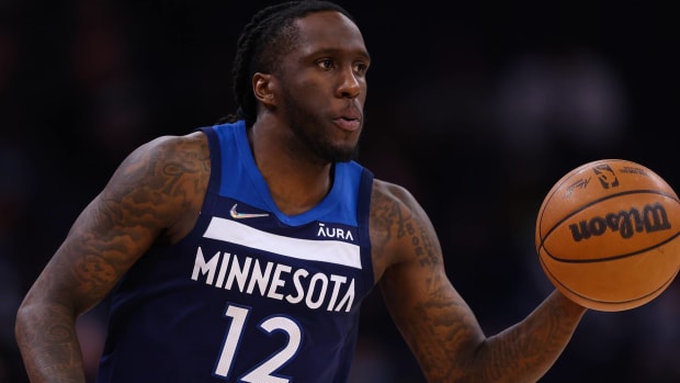 Timberwolves forward Taurean Prince dribbles a ball during a game.