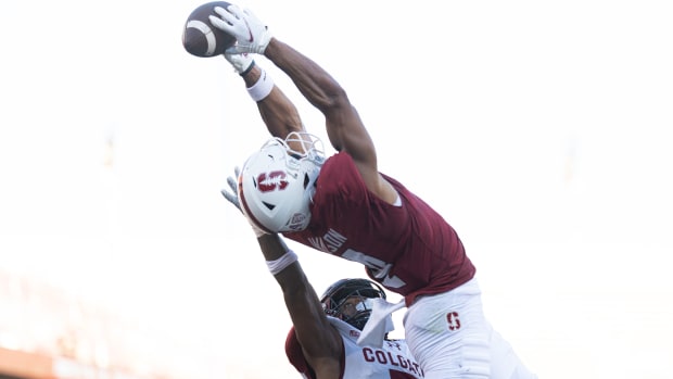Stanford Cardinal wide receiver Michael Wilson (4) catches the ball for a touchdown over Colgate Raiders defensive back Asauni Allen (7) during the second quarter at Stanford Stadium.