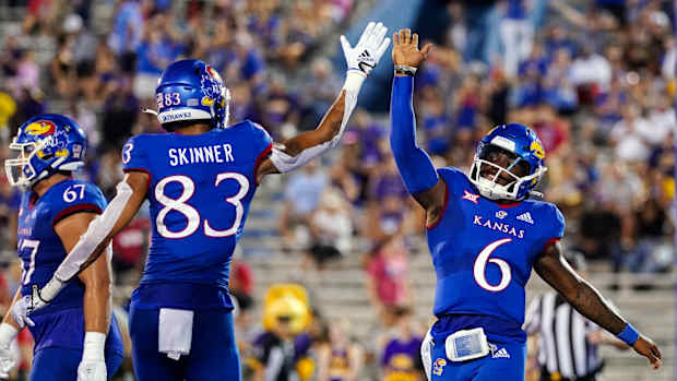 Sep 2, 2022; Lawrence, Kansas, USA; Kansas Jayhawks quarterback Jalon Daniels (6) celebrates with wide receiver Quentin Skinner (83) after scoring a touchdown against the Tennessee Tech Golden Eagles during the first half at David Booth Kansas Memorial Stadium. Mandatory Credit: Jay Biggerstaff-USA TODAY Sports