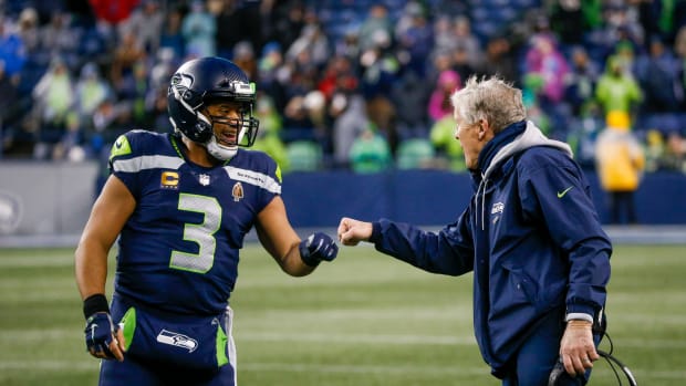 Jan 2, 2022; Seattle, Washington, USA; Seattle Seahawks quarterback Russell Wilson (3) bumps fists with head coach Pete Carroll during the fourth quarter two-minute warning against the Detroit Lions at Lumen Field. Mandatory Credit: Joe Nicholson-USA TODAY Sports