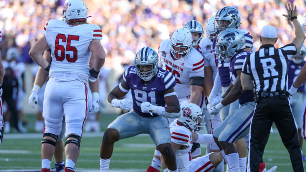 Sep 3, 2022; Manhattan, Kansas, USA; Kansas State Wildcats defensive end Felix Anudike-Uzomah (91) celebrates a sack of South Dakota Coyotes quarterback Carson Camp (18) during the first quarter at Bill Snyder Family Football Stadium. Mandatory Credit: Scott Sewell-USA TODAY Sports.