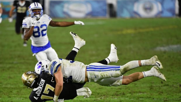Dec 22, 2020; Boca Raton, Florida, USA; Brigham Young Cougars linebacker Max Tooley (31) tackles UCF Knights wide receiver Amari Johnson (17) on the punt return during the second half at FAU Stadium. Mandatory Credit: Jasen Vinlove-USA TODAY Sports