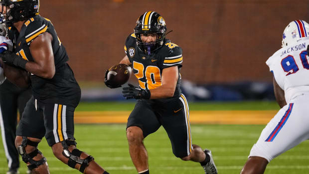 Sep 1, 2022; Columbia, Missouri, USA; Missouri Tigers running back Cody Schrader (20) runs the ball against Louisiana Tech Bulldogs defensive lineman DJ Jackson (90) during the second half at Faurot Field at Memorial Stadium. Mandatory Credit: Jay Biggerstaff-USA TODAY Sports