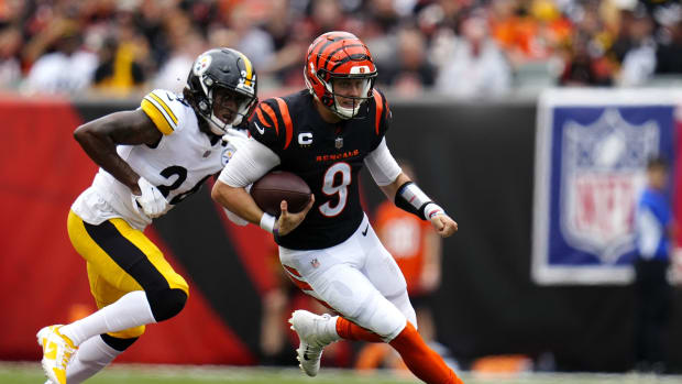 Sep 11, 2022; Cincinnati, Ohio, USA; Cincinnati Bengals quarterback Joe Burrow (9) runs as Pittsburgh Steelers safety Terrell Edmunds (34) defends during the second quarter of a Week 1 NFL football game at Paycor Stadium. Mandatory Credit: Sam Greene-USA TODAY Sports