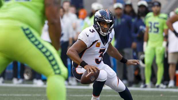 Denver Broncos quarterback Russell Wilson (3) looks to pass against the Seattle Seahawks during the first quarter at Lumen Field.