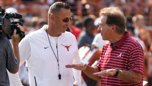 Texas Longhorns head coach Steve Sarkisian talks with Alabama Crimson Tide head coach Nick Saban before a game between the two teams.