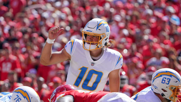 Sep 26, 2021; Kansas City, Missouri, USA; Los Angeles Chargers quarterback Justin Herbert (10) gestures on the line of scrimmage against the Kansas City Chiefs during the second half at GEHA Field at Arrowhead Stadium. Mandatory Credit: Denny Medley-USA TODAY Sports