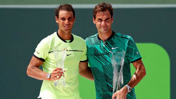 Rafael Nadal of Spain (L) and Roger Federer of Switzerland (R) hold the finalist and Butch Buchholz trophy, respectively, after their match in the men’s singles championship of the 2017 Miami Open at Crandon Park Tennis Center.