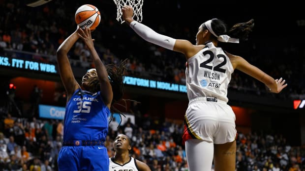 Sun's Jonquel Jones shoots as Las Vegas Aces' A'ja Wilson defends.