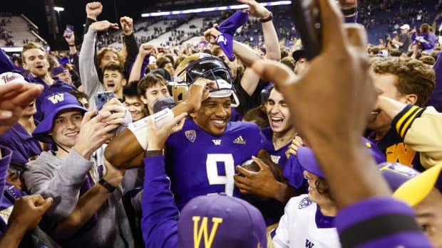 Washington Huskies quarterback Michael Penix Jr. (9) celebrates with fans following a 39-28 victory against the Michigan State Spartans at Alaska Airlines Field at Husky Stadium.