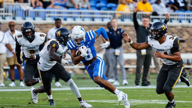 Sep 17, 2022; Durham, North Carolina, USA; Duke Blue Devils quarterback Jordan Moore (8) runs the ball against North Carolina A&T Aggies defensive back Ty Williams Jr. (26) and defensive end Henry Daniel (34) during the first half at Wallace Wade Stadium. Mandatory Credit: Jaylynn Nash-USA TODAY Sports